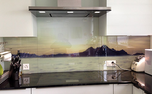 Panorama photo of an evening atmosphere on glass kitchen mirror.