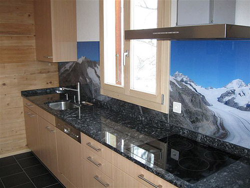 Glass kitchen back wall with panoramic photo of the Great Aletsch Glacier