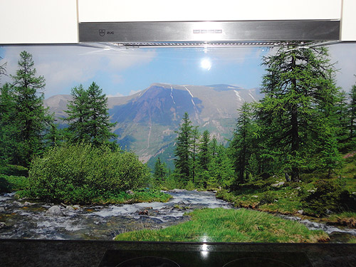 Glass kitchen back panel with panoramic photo of a mountain landscape.