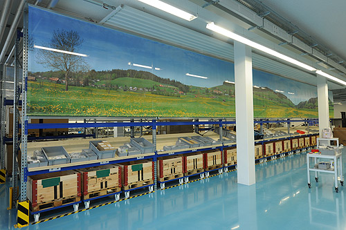 Large panoramic photos as partitions in production hall.