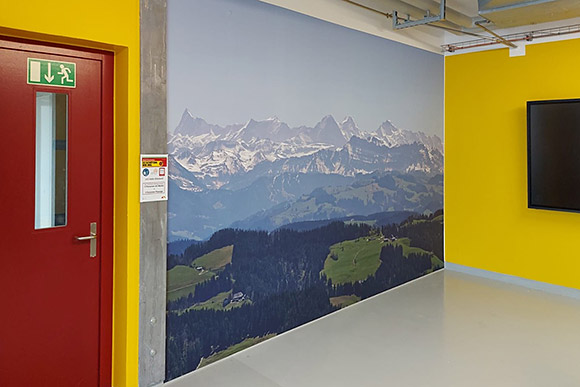Berner Alpen und Emmentaler Hügel auf Wandbild in Aufenthaltsraum.